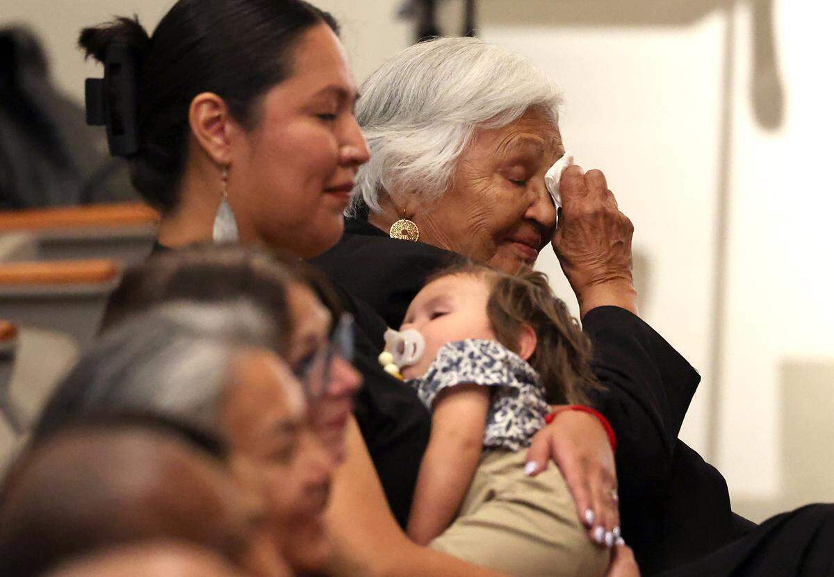 Ina Mae Brown McNeil, right, wipes a tear from her eye as her son, Joseph McNeil Jr., speaks about his father, Maj. Gen. Joseph McNeil during a memorial service at North Carolina A&T State University in Greensboro on Thursday. 