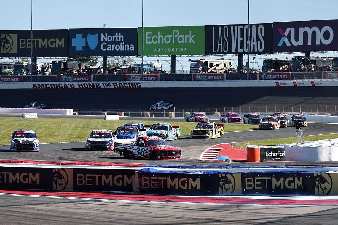 Chandler Smith, driver of the #38 The Pete Store Ford, Corey Heim, driver of the #11 Mobil 1 Toyota, and Kris Wright, driver of the #16 F.N.B. Corporation Chevrolet, race during the NASCAR Craftsman Truck Series EcoSave 250 at Charlotte Motor Speedway on October 03, 2025 in Concord, North Carolina. 