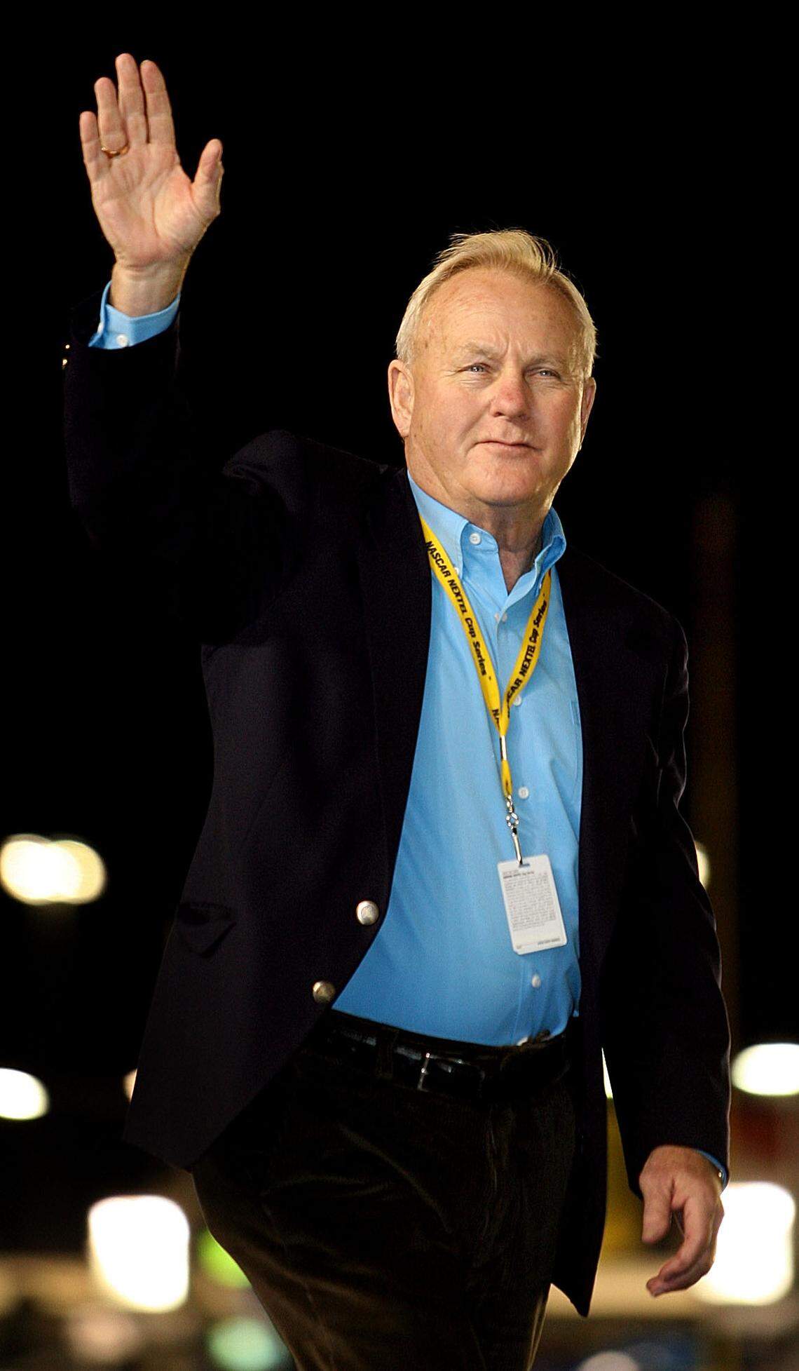 Humpy Wheeler waves to the crowd while being intoduced at a race at Charlotte Motor Speedway in 2006.