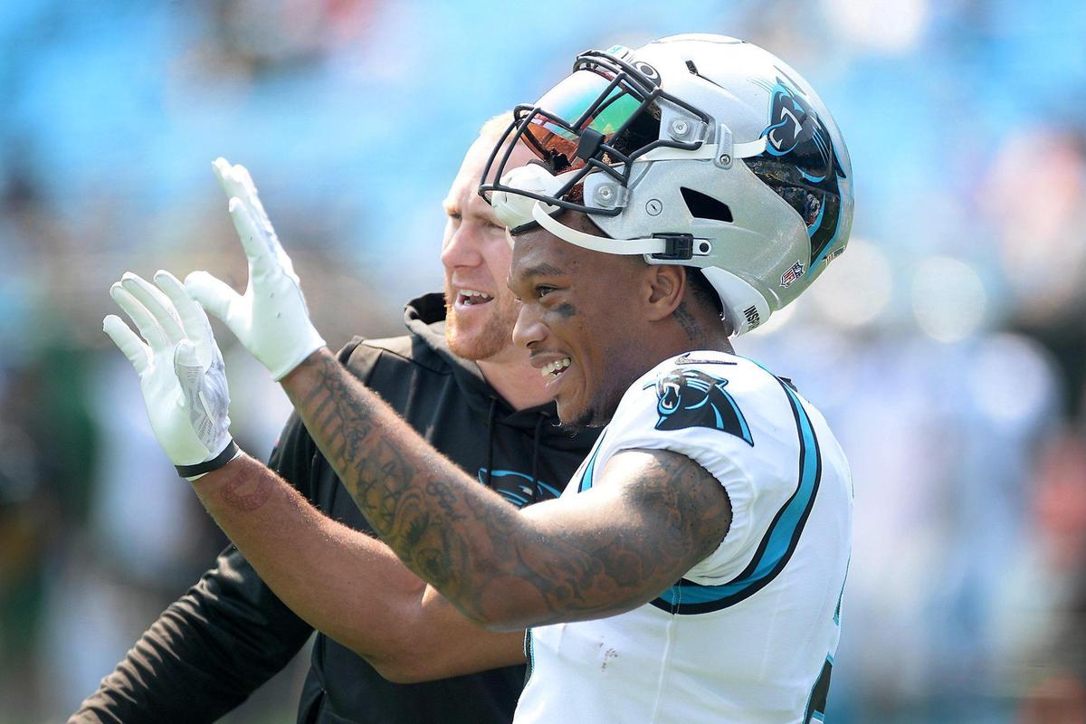 Carolina Panthers wide receiver DJ Moore, right, and offensive coordinator Joe Brady, left, speak prior to the season opener game against the New York Jets at Bank of America Stadium in Charlotte, NC on Sunday, September 12, 2021.