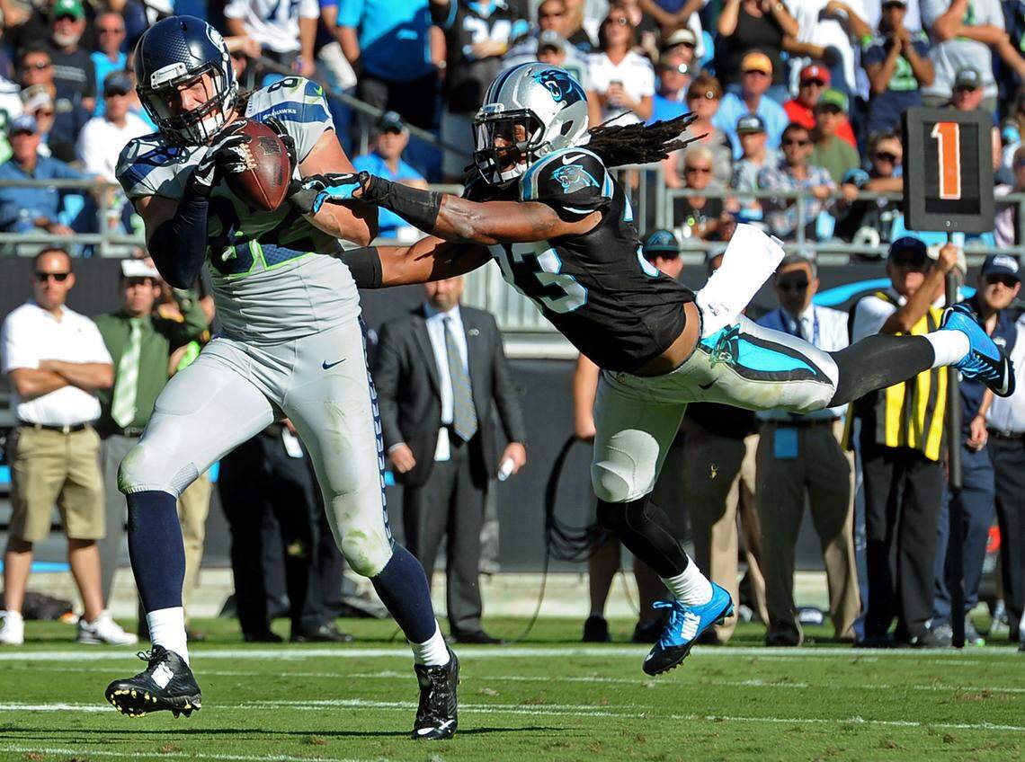 Seattle’s Luke Willson, left, catches the game-winning pass as Panthers safety Tre Boston dives after him in their October 2014 game.