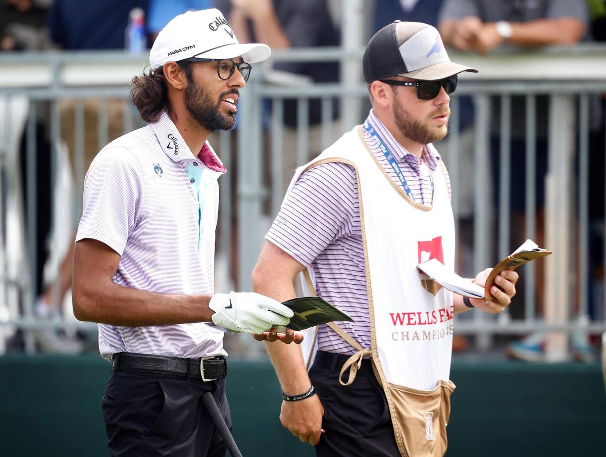 Akshay Bhatia, left, and his caddie, right, look down the first greenway prior to teeing off during second round action in the Wells Fargo Championship at Quail Hollow Club in Charlotte, NC on Friday, May 5, 2023.