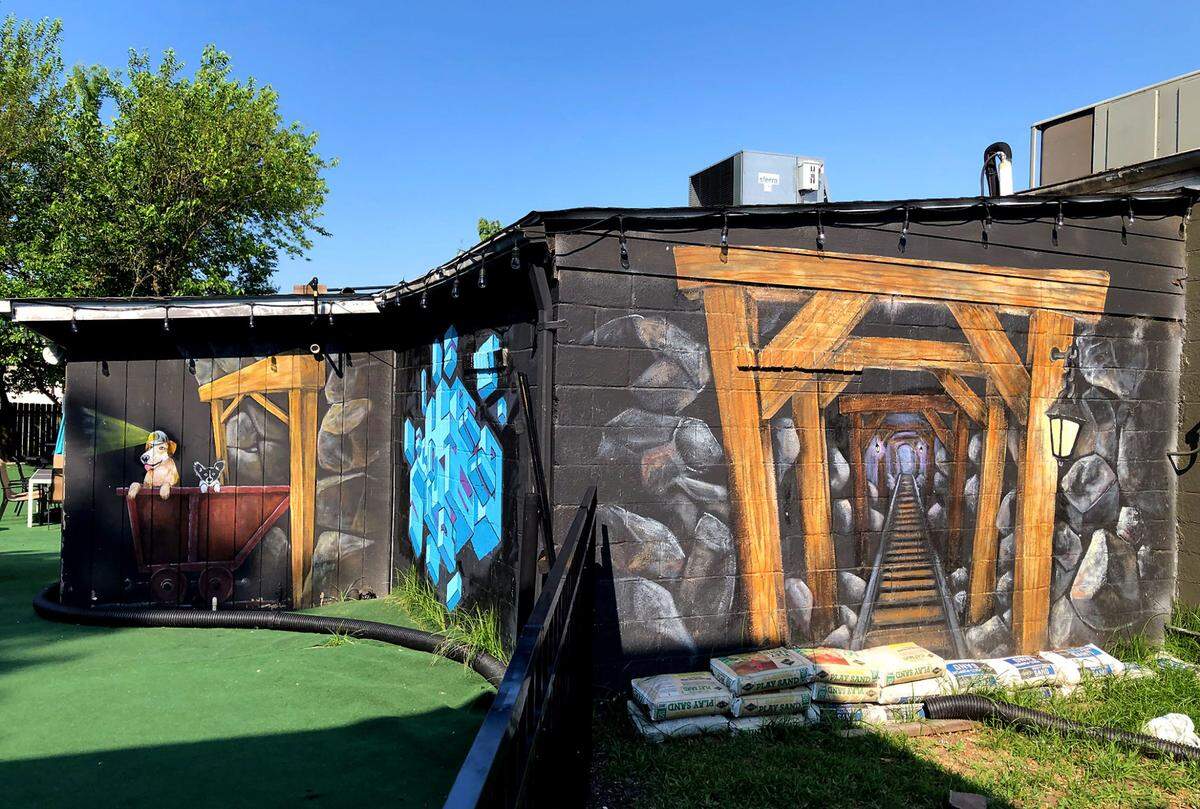 A mural on the Max and Lola coffee shop playfully depicts Charlotte’s early gold mining history along Summit Avenue. A nearby marker states that the Rudisill Gold Mine was the largest and most productive of the gold mines in the Charlotte gold mining region.