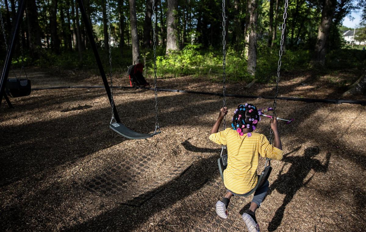 A little girl swings at Albemarle Road Park in Charlotte, N.C., on Friday, April 16, 2021.