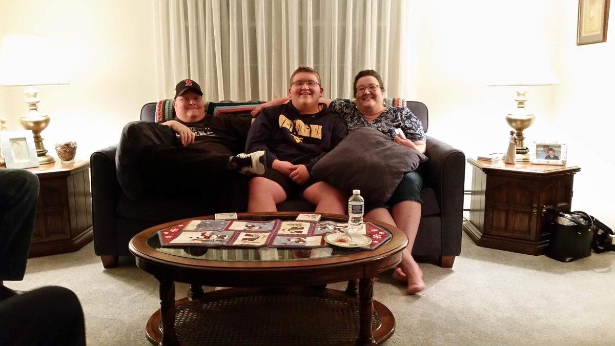 From left to right: Eric, Adam and Linda Oakes, in their home in Sterling, Virginia.