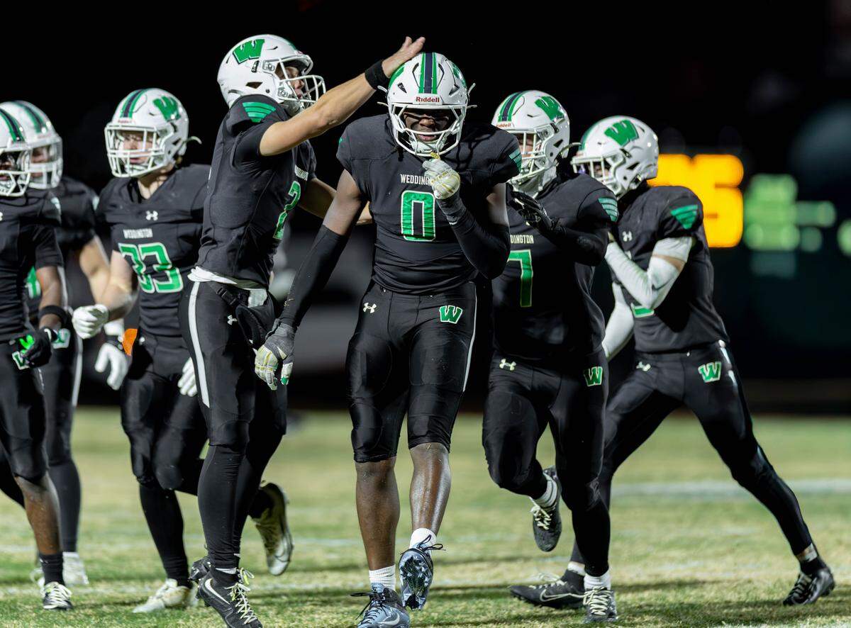 Weddington teammates celebrate with TJ Davis (0) after third down stop late in second half action. Weddington would host Independence in the NCHSAA quarterfinal playoff game Friday, November, 28 2025.
