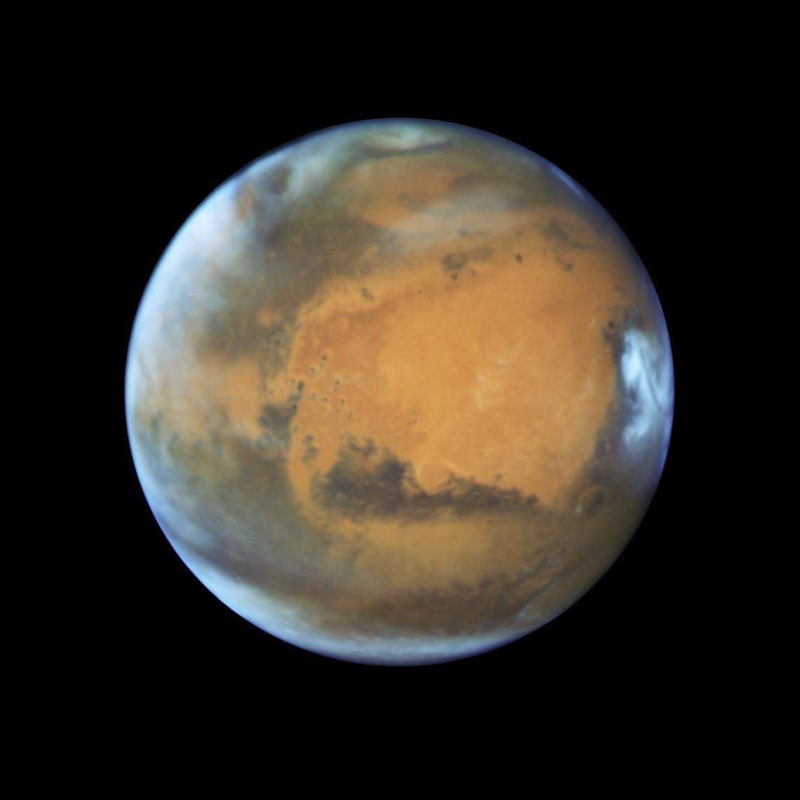 Mars, seen here in a magnified NASA image, will pass the closest to Earth since 2003 on Friday, appearing especially bright in the night sky. The planet’s peak brightness will linger for about a week.