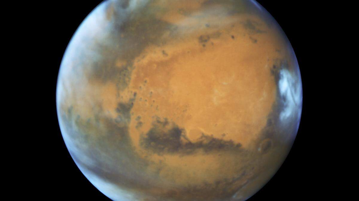 Mars, seen here in a magnified NASA image, will pass the closest to Earth since 2003 on Friday, appearing especially bright in the night sky. The planet’s peak brightness will linger for about a week.