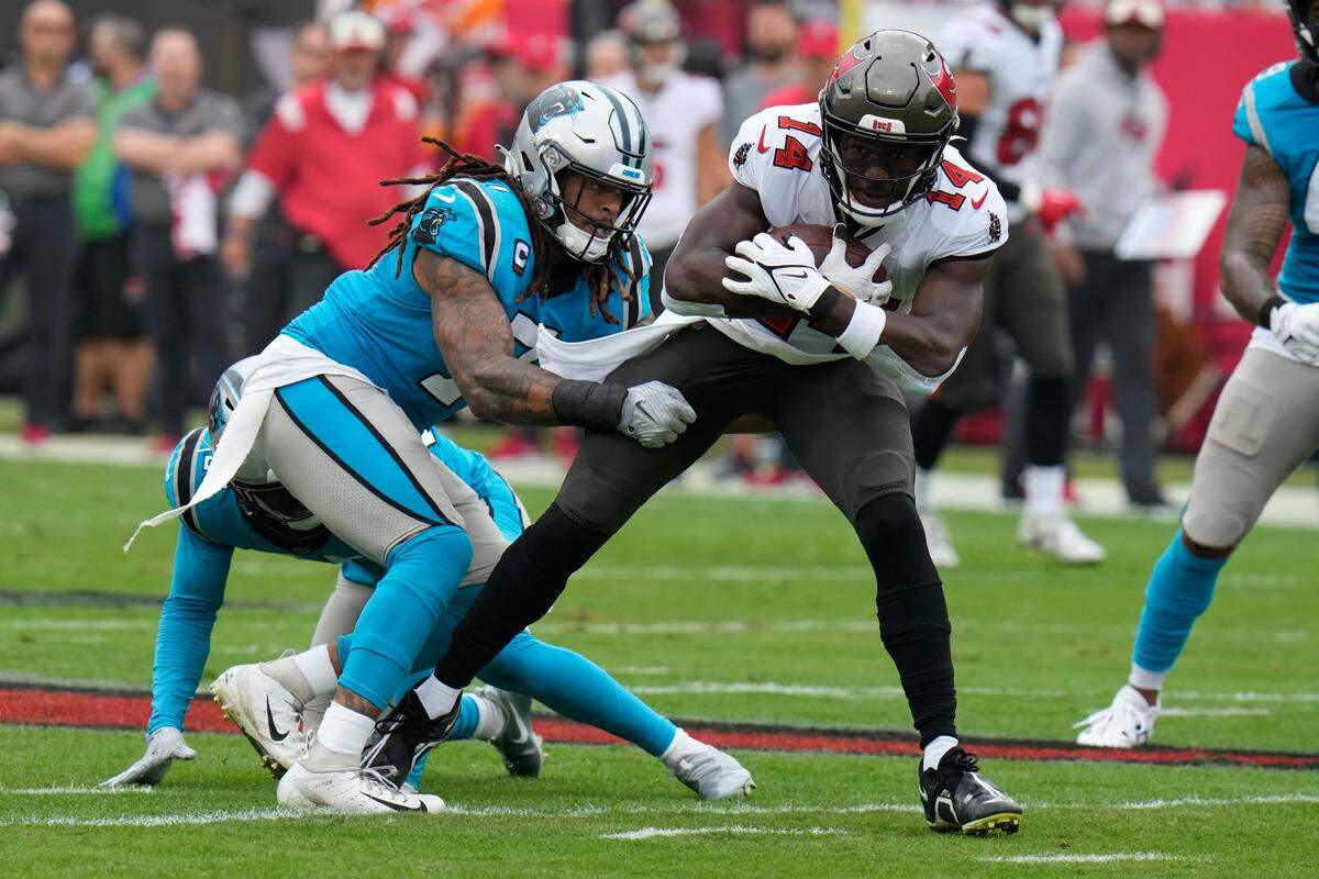 Tampa Bay Buccaneers wide receiver Chris Godwin is tackled by Carolina Panthers linebacker Shaq Thompson during the first half of an NFL football game between the Carolina Panthers and the Tampa Bay Buccaneers on Sunday, Jan. 1, 2023, in Tampa, Fla. (AP Photo/Chris O’Meara)