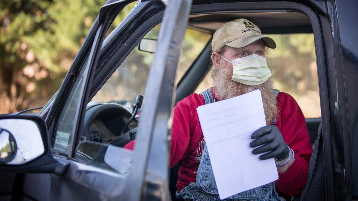 Randy Lewis gets out of his truck behind a Lowes Foods grocery store in Mebane, N.C. at 8:54 a.m. on Tuesday, April 14, 2020. Lewis, co-owner of Ran-Lew Dairy Milk Company, doesn’t usually deliver to local markets. However, it’s one of the things he’s doing to maintain business after the coronavirus shut down dining in restaurants where he sells much of his product.