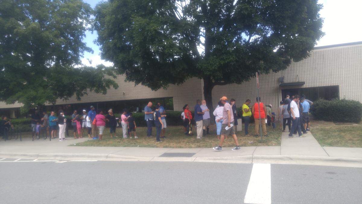 Hardee's customers wait outside the Northwest Health Department on Beatties Ford Road Wednesday afternoon for a vaccination against hepatitis A. The county is urging people who at the restaurant on Little Rock Road from June 13 to 23 to get a vaccination.