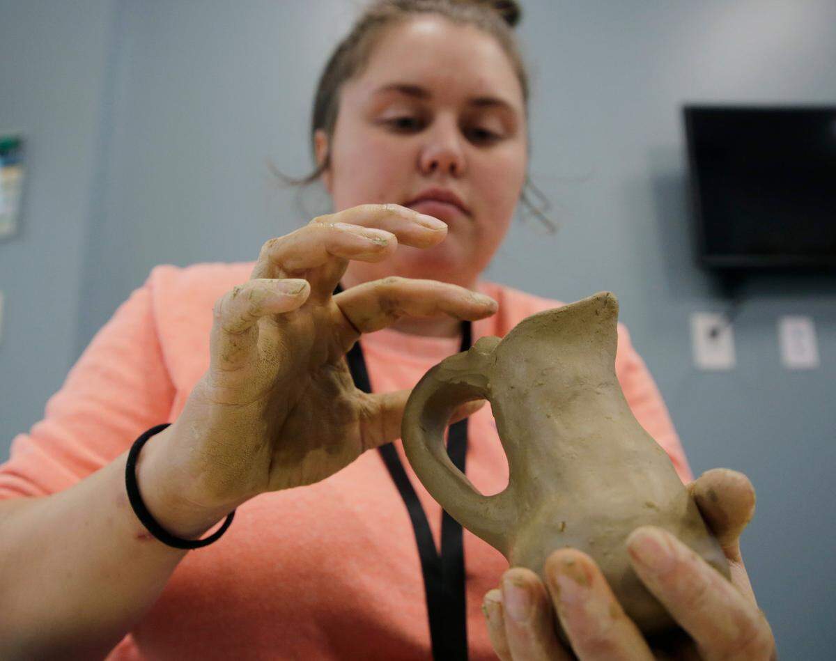 Cheyenne Sanders makes a clay vase at the Catawba Senior Center on Dec. 9, 2022. Catawba people have long created pottery for cultural, practical and commercial reasons.