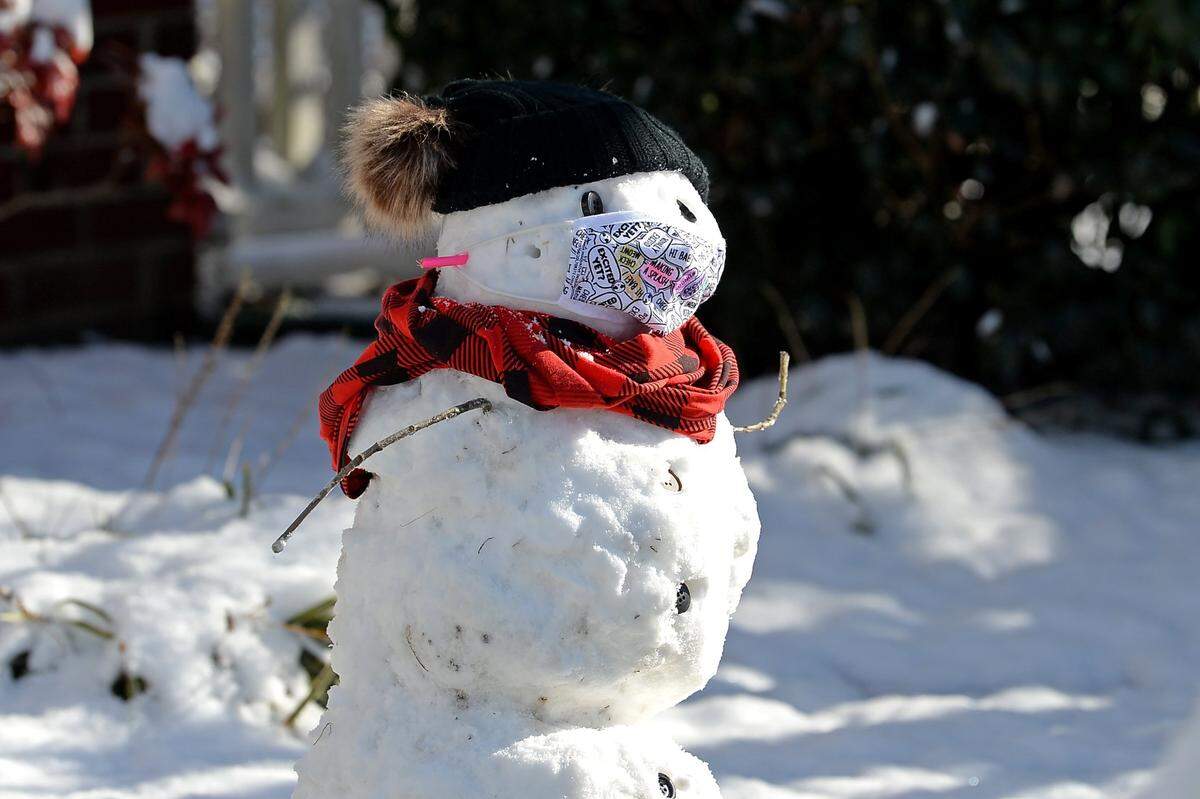 Sophia Bhayani, 8, and her mother, Jasna Bhayani’s snowman comes complete with a mask in the Village of Lake Park in Union County in January 2022.