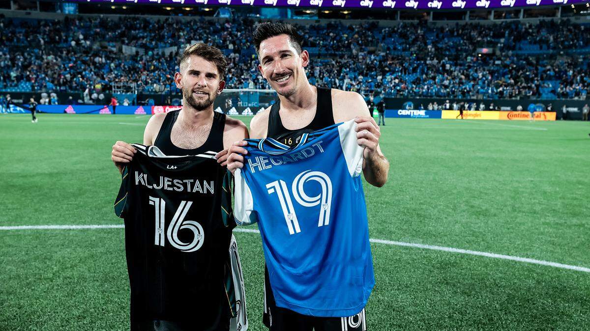 Charlotte FC rookie Chris Hegardt poses with LA Galaxy veteran Sacha Kljestan after exchanging jerseys at Bank of America Stadium in Charlotte, N.C. Kljestan visited Hegardt in 2010 when Hegardt was a cancer patient at Children’s Hospital LA.
