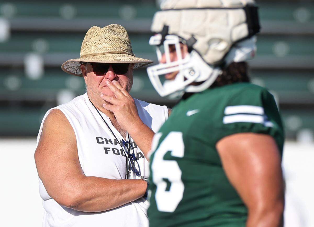 Charlotte 49ers head coach Biff Poggi, left, watches as players move through drills during the team’s first summer training camp practice on Friday, August 3, 2024.