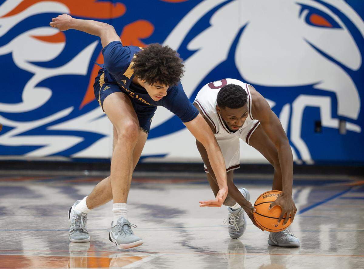 East Meck's Jordan Buzzard (left) and West Meck's Thomas Colbert (right) battle for the loose ball. West Meck Men's basketball team would take on East Meck at the Phenom Hoops Mike Gminski Classic at Marvin Ridge High School December 27, 2025.