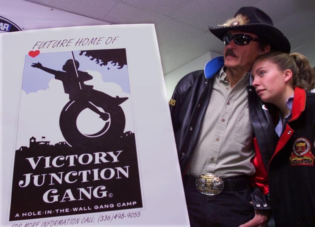 Montgomery Lee Petty, then 14, leans on her grandfather, racing great Richard Petty, as she listens to her dad, Kyle Petty, not shown, announce that the Petty family is founding The Victory Junction Gang Camp. The announcement came during a news conference at the North Carolina Speedway near Rockingham in 2000.