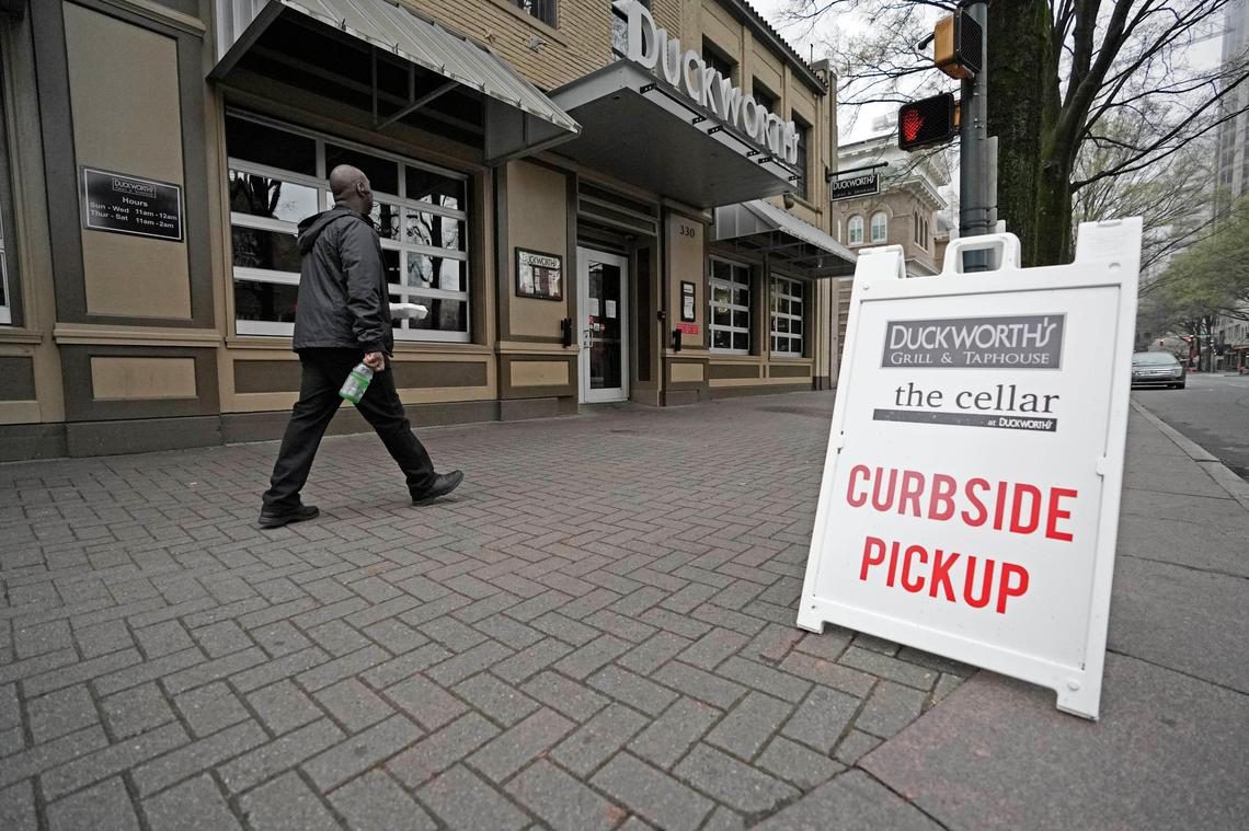 Signage in front of Duckworth’s Grill & Taphouse advertises pickup service in reaction to the coronavirus pandemic in uptown Charlotte on Tuesday morning, March 24, 2020.