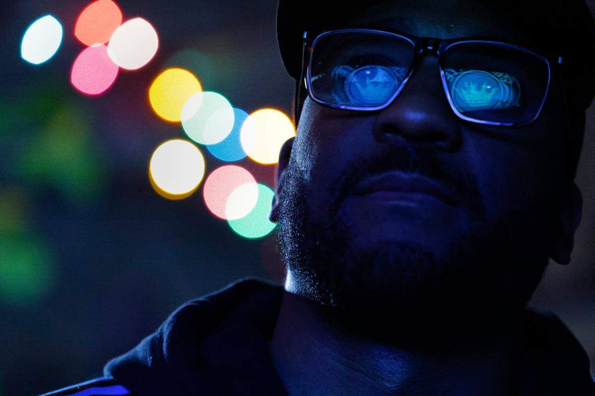 The Charlotte FC logo is reflected in the glasses of Elliotte Douglas-Middleton, of Charlotte, N.C. as he watches Charlotte FC take on D.C. United during a watch party at Salud Beer Shop in Charlotte, Saturday, Feb. 26, 2022. D.C. United beat Charlotte FC 3-0.