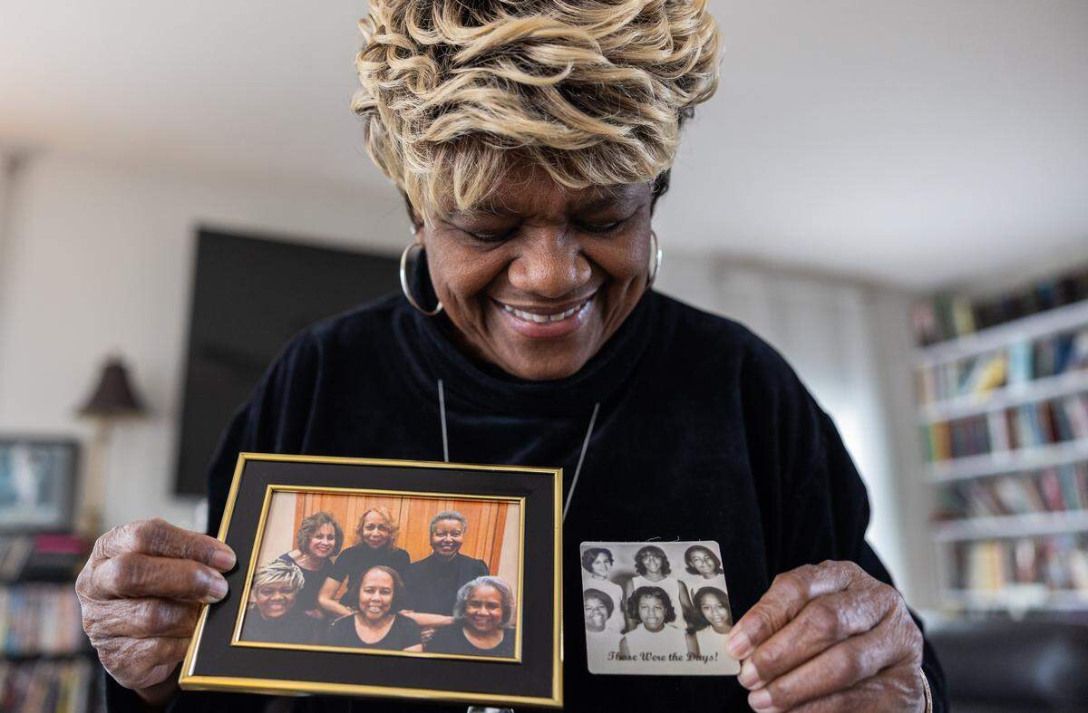 Gwen Carter-Adamson looks at photos of her friends from childhood in High Point, N.C., on Friday, March 20, 2026. 