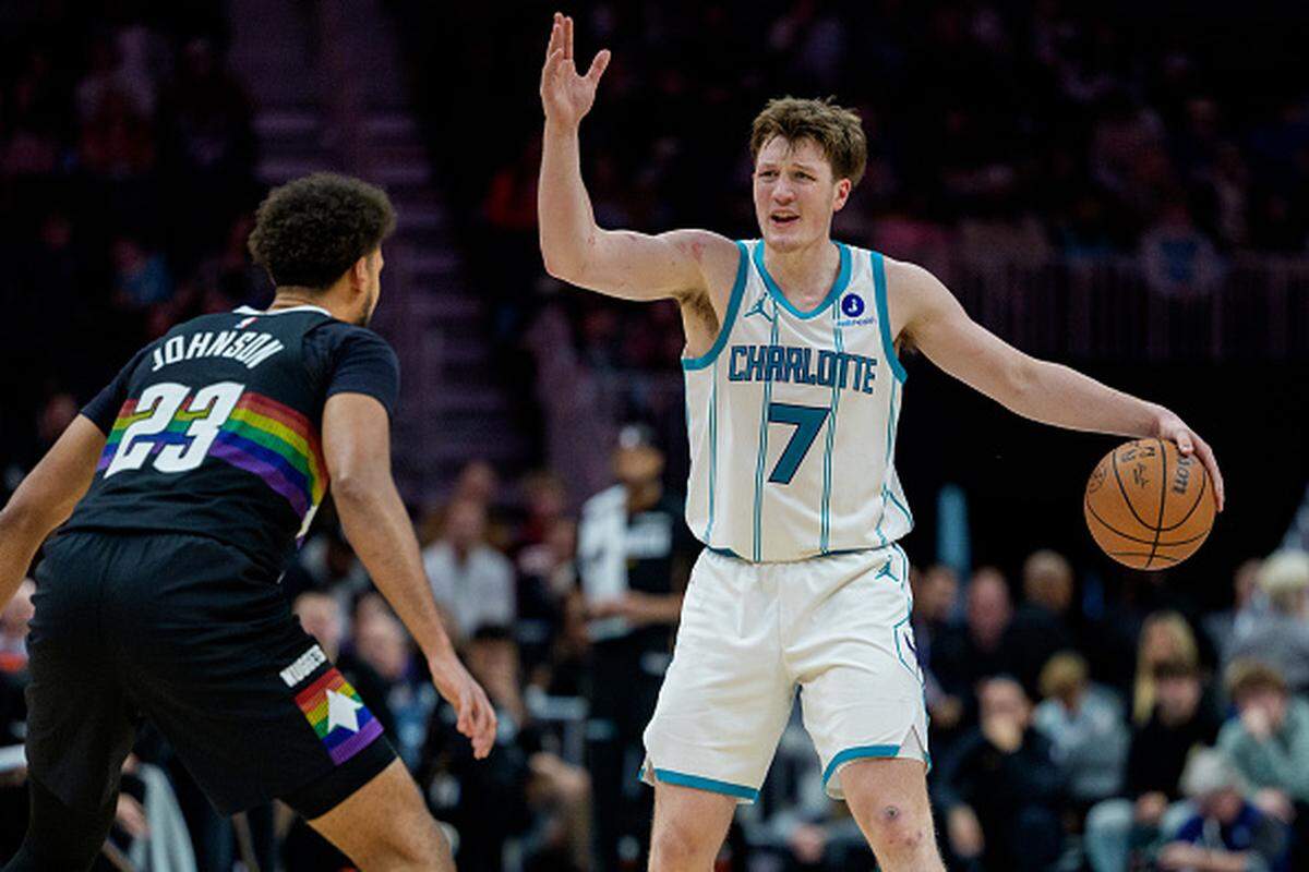 Kon Knueppel of the Charlotte Hornets brings the ball up court while guarded by Cameron Johnson of the Denver Nuggets in the second half during their game at Spectrum Center.