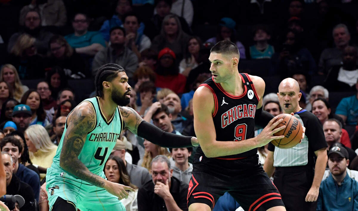 Chicago Bulls center Nikola Vucevic (9) looks to shoot as he is defended by Charlotte Hornets center Nick Richards (4) during the first half at the Spectrum Center. Sam Sharpe-Imagn Images