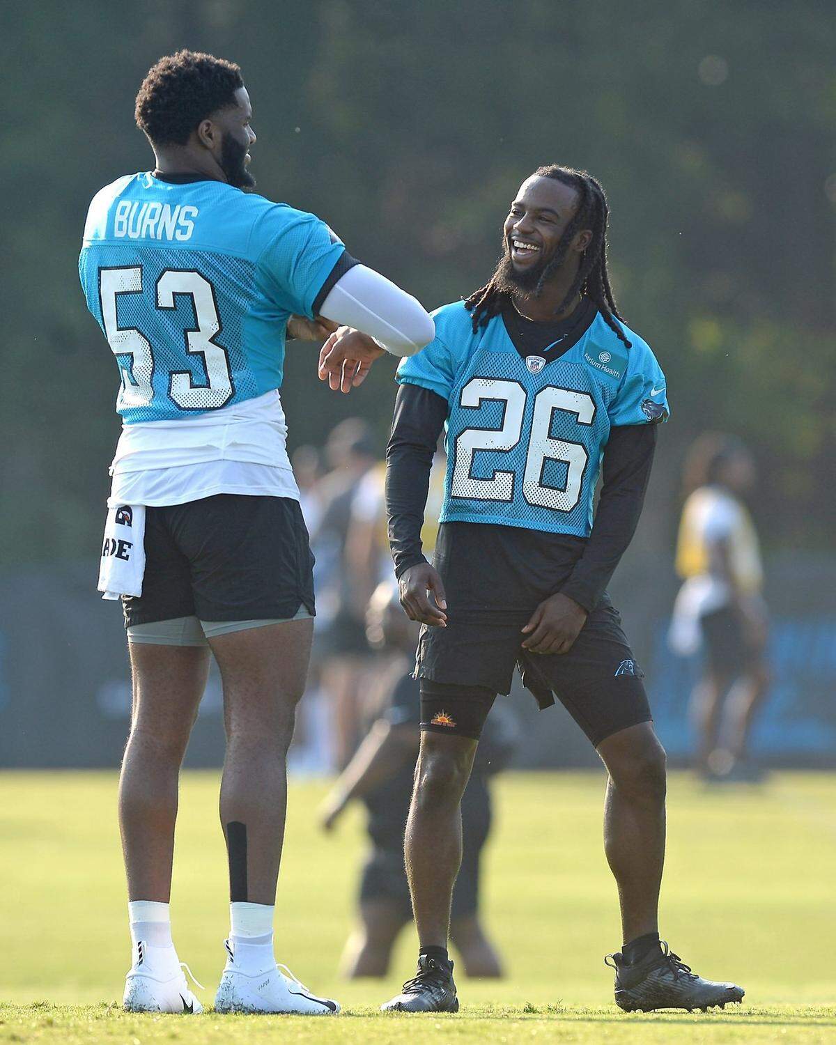 Carolina Panthers defensive end Brian Burns, left, and cornerback Donte Jackson (26) share a laugh in July.