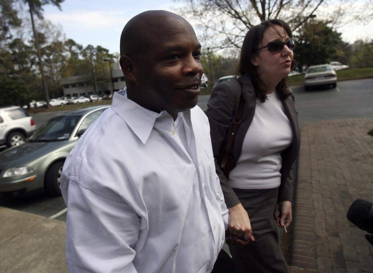 Glenn Edward Chapman walks with his attorney, Jessica Leaven, into the Academy of Trial Lawyers in Raleigh after being released from Central Prison.