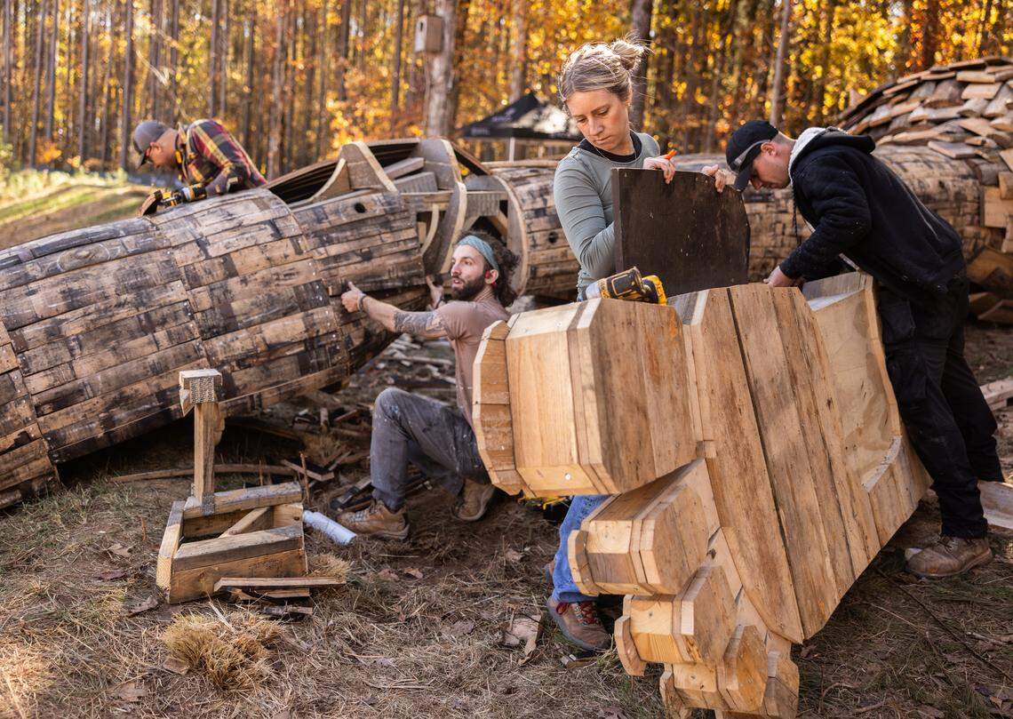 Volunteers work on constructing a giant troll sculpture named Pete with the Big Feet by Danish artist Thomas Dambo in Charlotte, N.C., on Thursday, November 6, 2025.