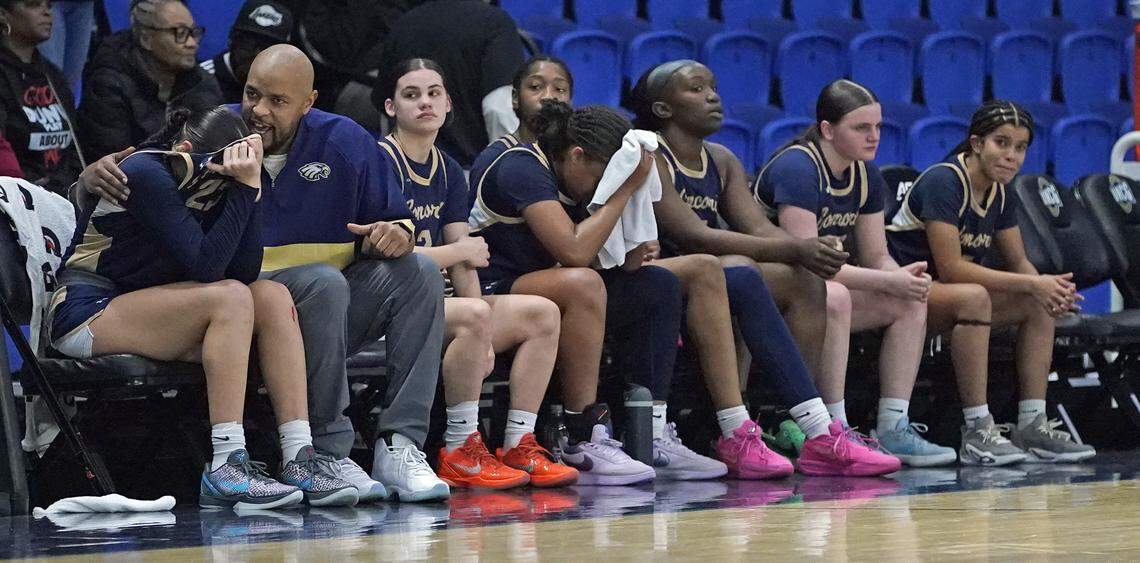 Concord Academy head coach DeAngelo Alexander, second from left, consoles Justice Alexander after the Eagles lost to Grace Christian in the N.C. Independent Schools Athletic Association's 3A women's basketball championship game on Friday, Feb. 27, 2026, in Greensboro, N.C. (Credit: Bill Kiser/Special to the Charlotte Observer)