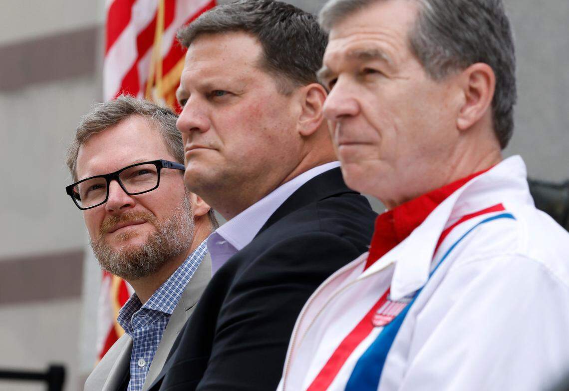 From left, Dale Earnhardt Jr., NASCAR Chief Operating Officer Steve O’Donnell and N.C. Governor Roy Cooper listen as Speedway Motorsports President and CEO Marcus Smith speaks during a press conference announcing that the NASCAR All-Star Race will be held at North Wilkesboro Speedway in May 2023.