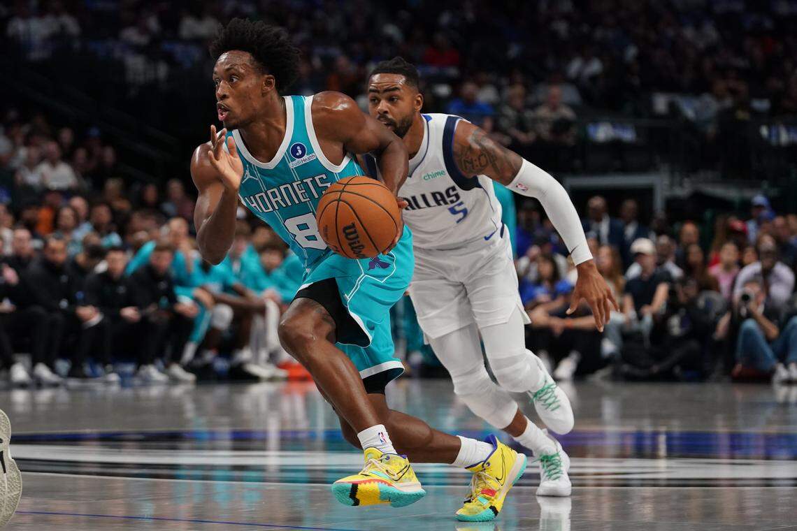 Charlotte Hornets guard Collin Sexton (8) goes by Dallas Mavericks guard D'Angelo Russell (5) in the first half of a game at American Airlines Center.