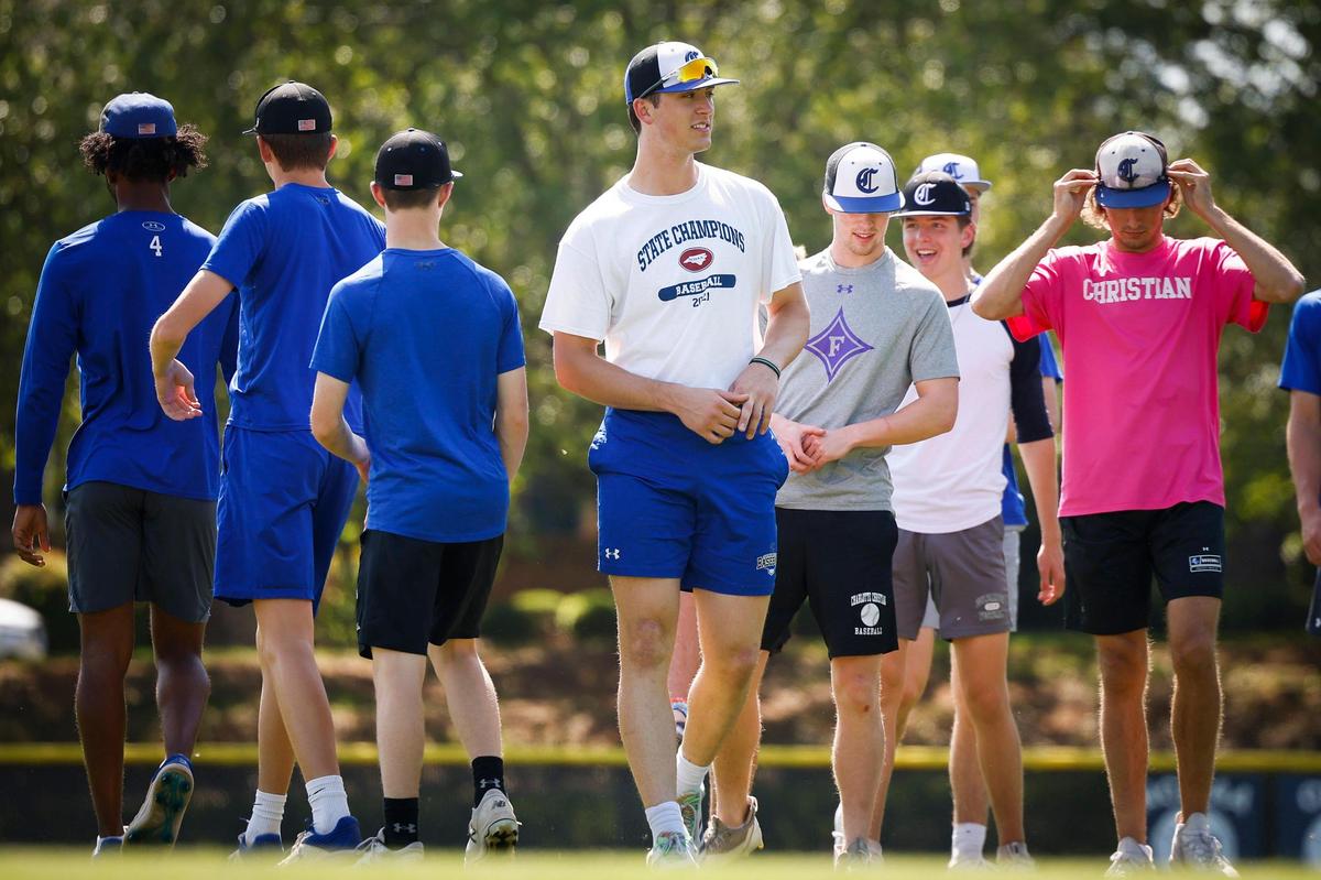 Charlotte Christian’s Judd Utermark, center, runs drills with teammates during practice at Charlotte Christian School in Charlotte, N.C., Wednesday, April 27, 2022. This season Utermark broke a 22-year old school record for home runs and as of Monday, April 25 he leads the nation win home runs.