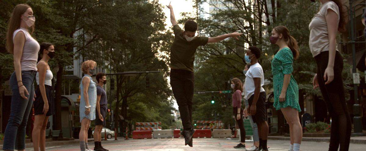 Dancers from Charlotte Ballet, including Andrès Trezevant (center), perform a piece called “Uptown Collective” on Tryon Street. The piece was inspired by the Black Lives Matter mural uptown and designed to draw attention to social justice issues in Charlotte. It was filmed at the mural.