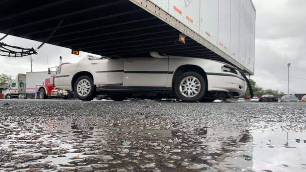 A driver got wedged beneath a semi-truck after slamming into it while it was making a turn Wednesday in Murfreesboro, Tennessee, police said.