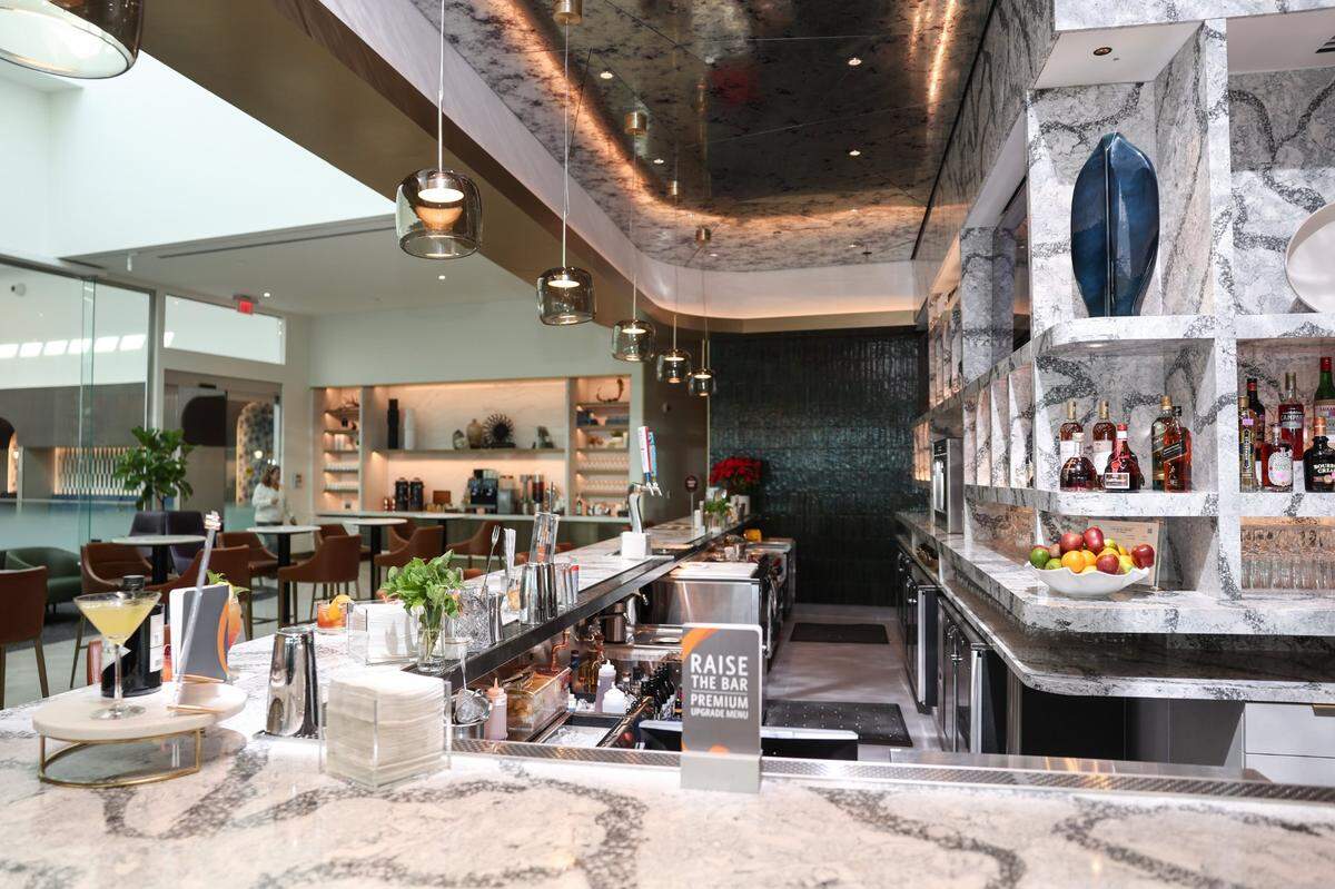 In addition to a full bar of complimentary cocktails, guests can enjoy espresso drinks and a hot cocoa bar inside the new Delta Sky Club at Charlotte Douglas International Airport.