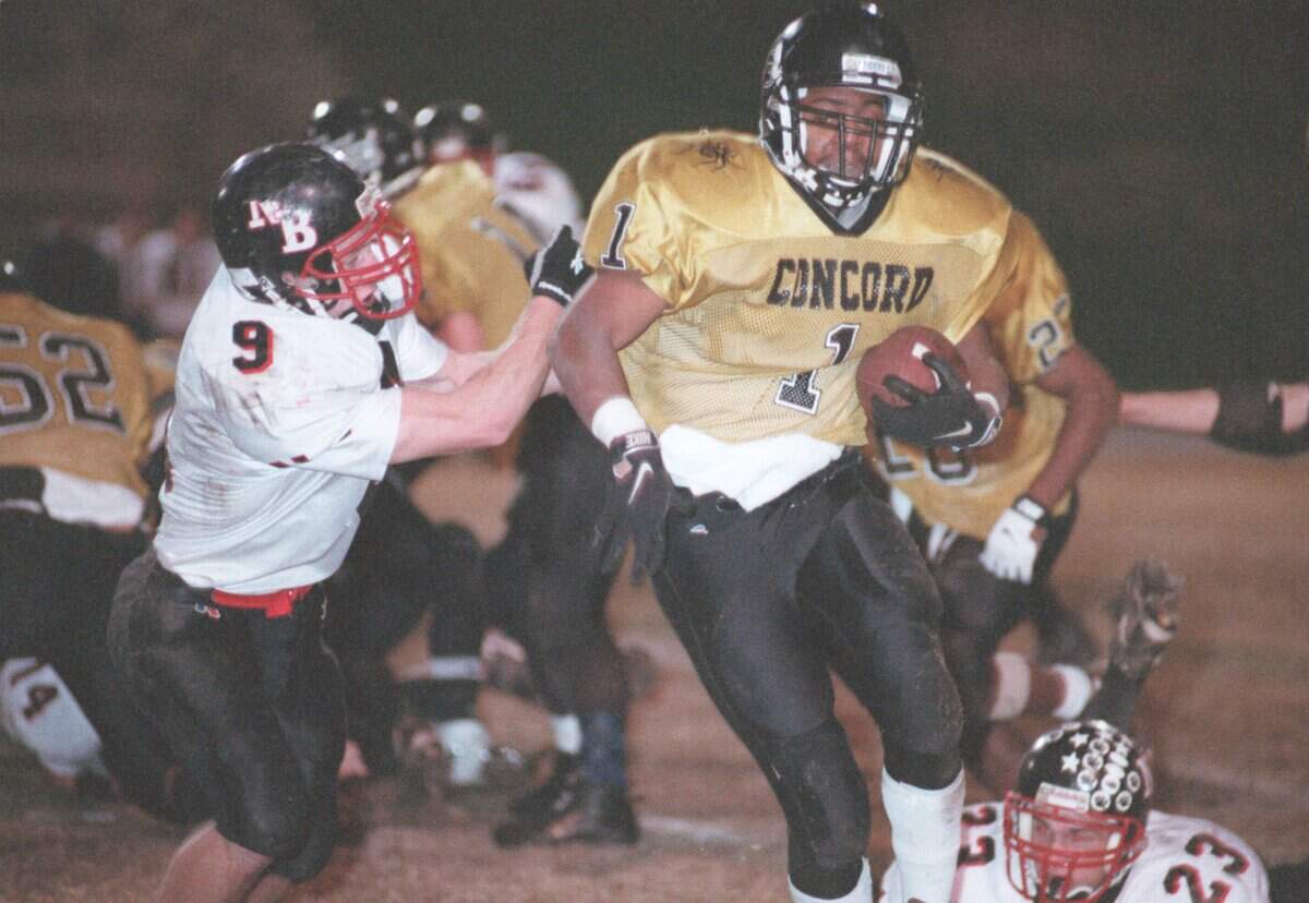 11/27/98   Brad Boone #9 from North Buncombe chases Concord's Kenneth McClamrook during the 3A championship game at Concord High School