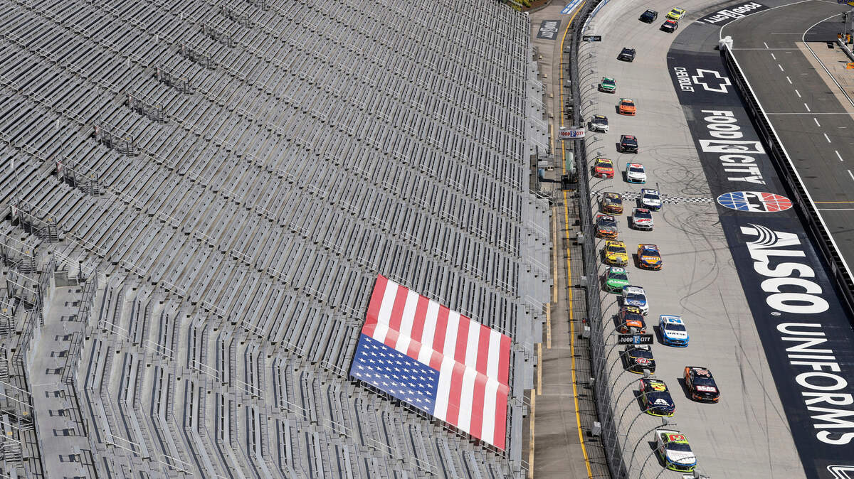 FILE - In this May 31, 2020, file photo, cars speed past empty stands during a NASCAR Cup Series auto race at Bristol Motor Speedway in Bristol, Tenn. Tennis and golf tournaments could be in real financial trouble if they are held without spectators because of the coronavirus pandemic. The biggest team leagues such as the NFL and NBA seem to be in good shape because they derive most of their money from TV contracts worth billions each season. NASCAR also relies mainly on broadcast rights fees. (AP Photo/Mark Humphrey, File)