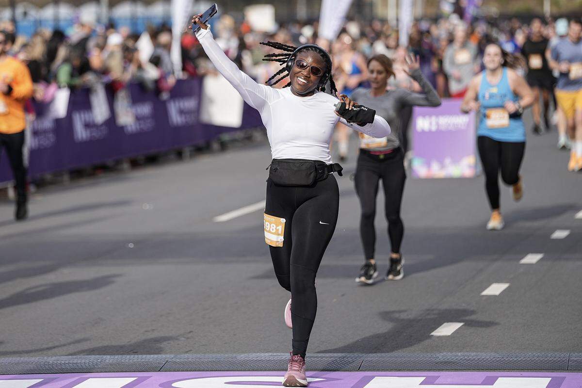 Participants celebrate after competing in the Novant Health Charlotte Marathon Saturday, Nov. 15, 2025, in Charlotte, N.C.