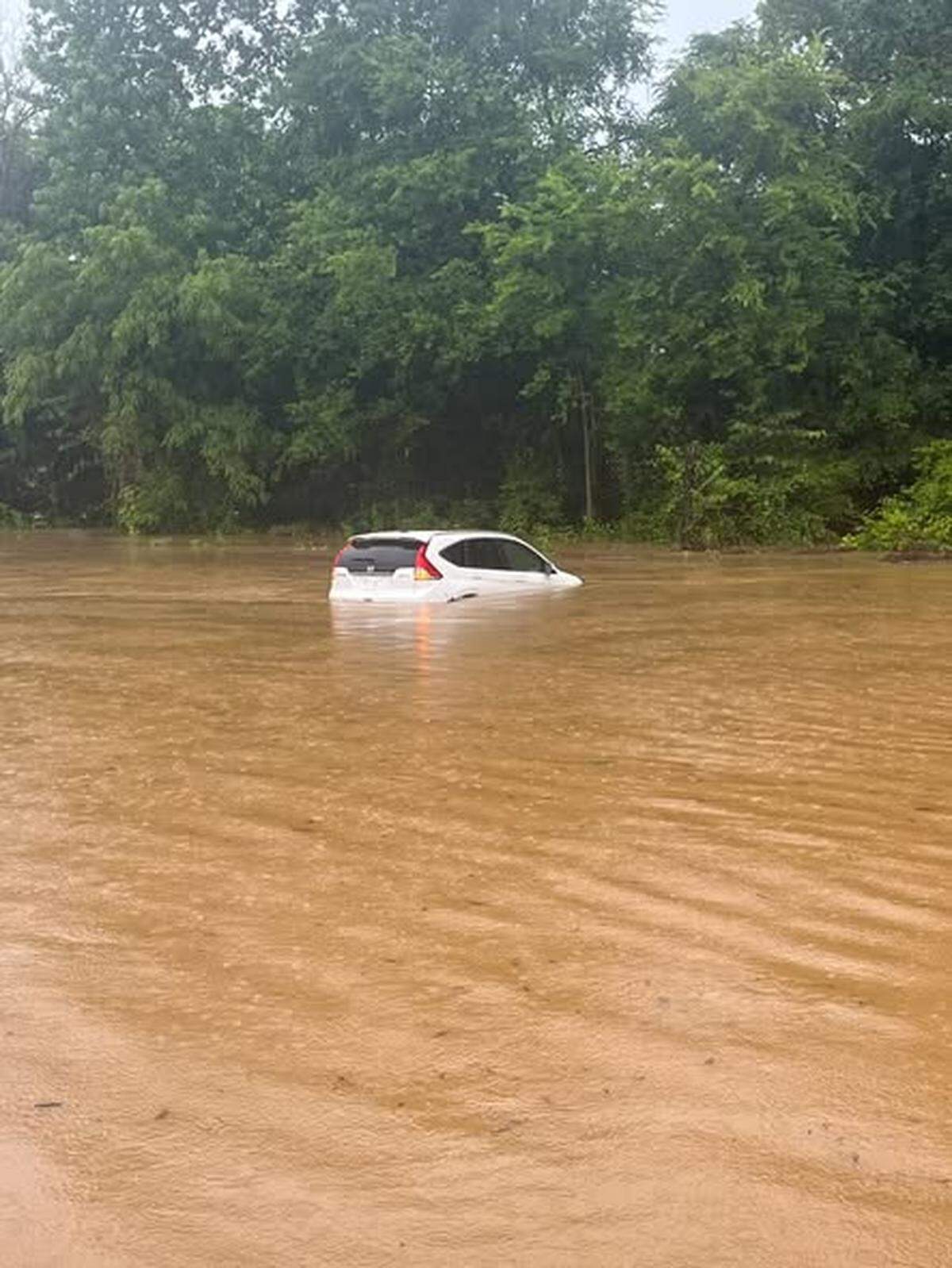 This photo released Saturday by the Union County Sheriff’s Office shows a car in flood waters almost above its tires.