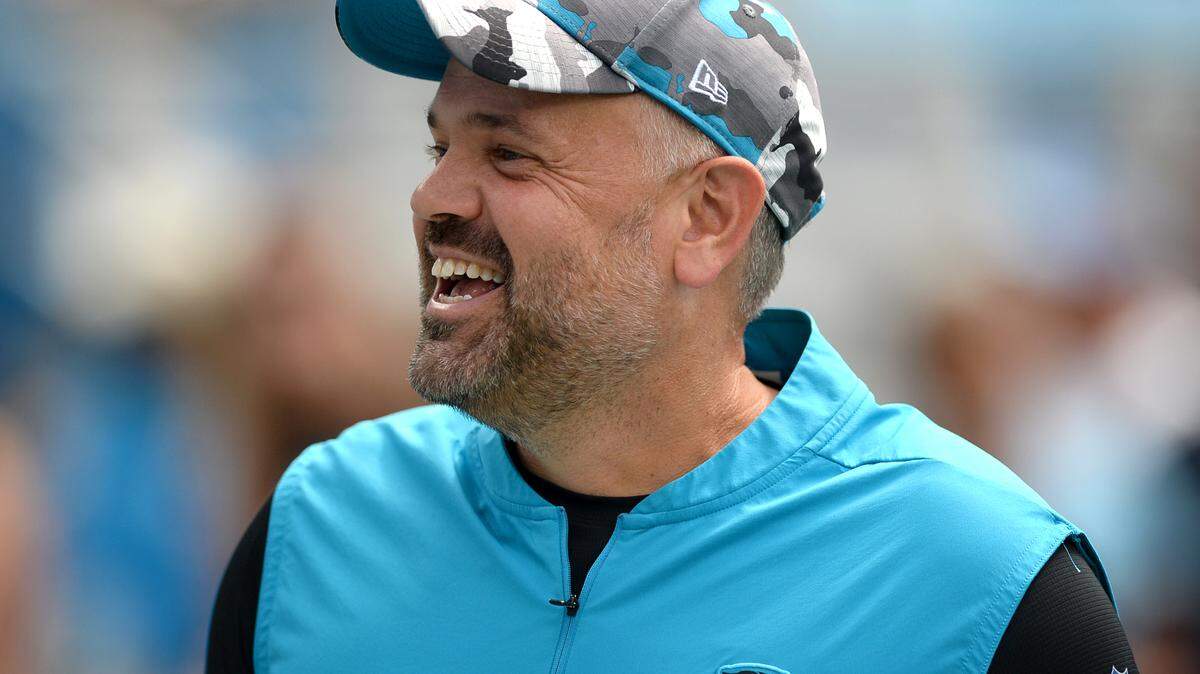 Carolina Panthers head coach Matt Rhule smiles as he greets people along the sideline prior to first quarter action against the Cleveland Browns at Bank of America Stadium on Sunday, September 11, 2022.