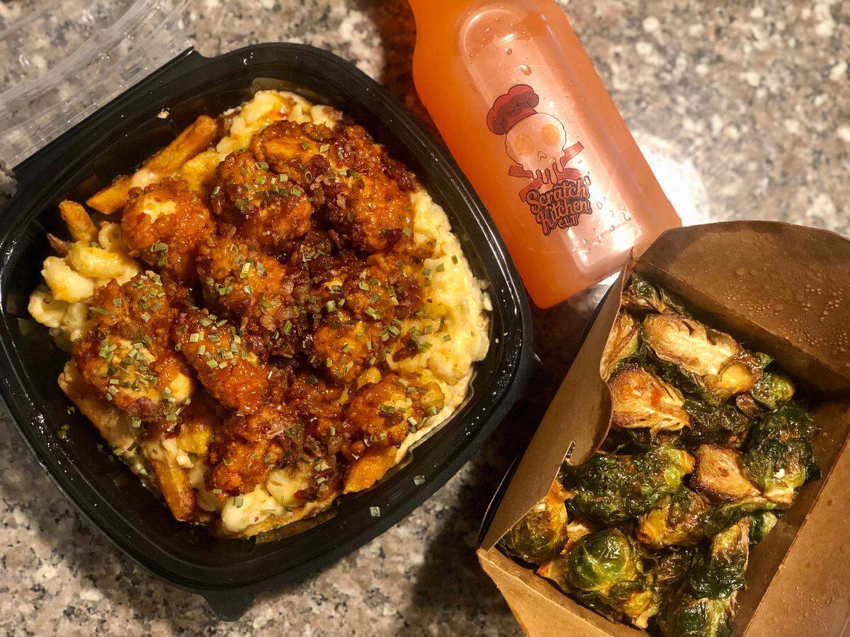 Scratch Kitchen’s Mac Attack (maple buffalo tenders over mac and cheese and fries/ tater tots), with honey Sriracha Brussels sprouts and pineapple lemonade.