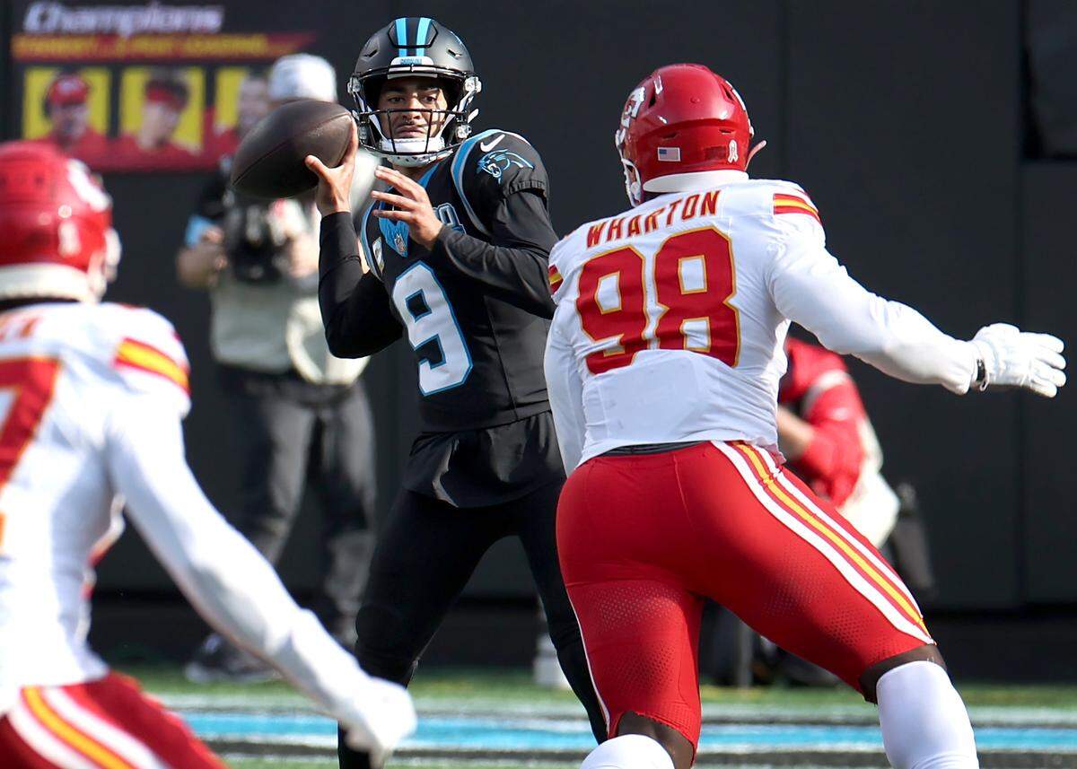 Carolina Panthers quarterback Bryce Young, center, drops back to pass as the Kansas City Chiefs defense rushes at Bank of America Stadium in Charlotte, NC on Sunday, November 24, 2024.