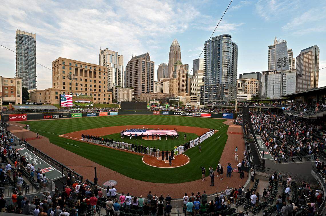 The Charlotte, NC skyline provides the backdrop as fans stand for the national anthem at Truist Field on Tuesday, April 2, 2024.