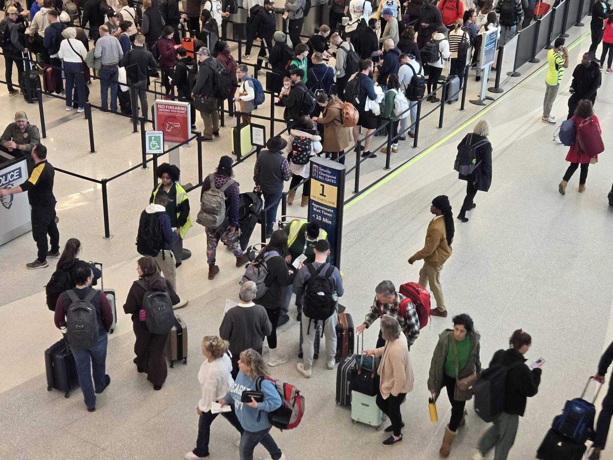 A long line forms for a security checkpoint at Charlotte Douglas International Airport on Dec. 19. Expect those lines to be even longer during the winter holiday travel season.