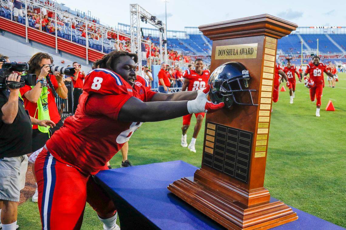Florida Atlantic Owls defensive lineman Evan Anderson (8) rips-off the Florida International University helmet from the Don Shula Award Trophy after winning the game at FAU Stadium in Boca Raton, Florida on Saturday, October 2, 2021.