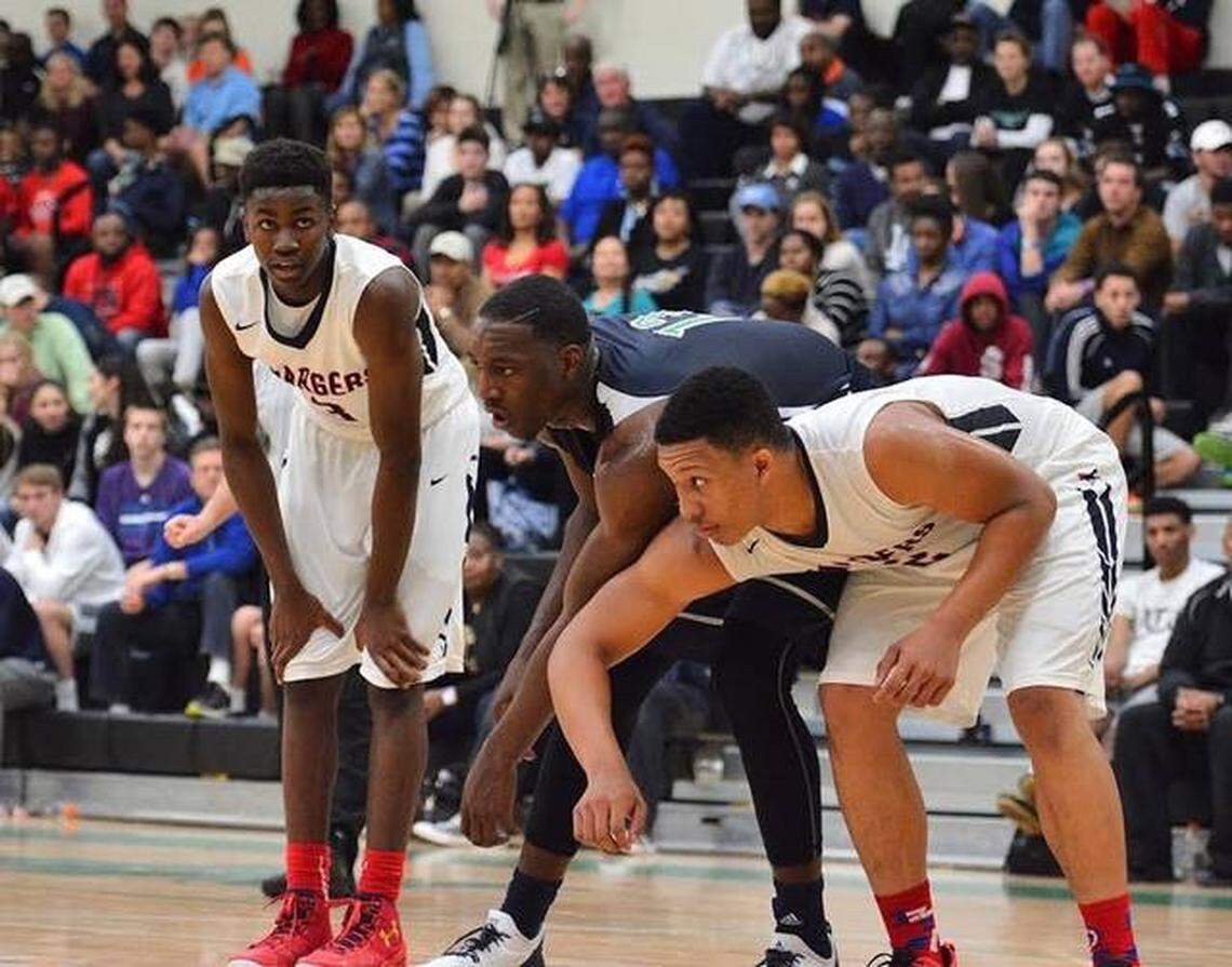 Providence Day guard Trey Wertz (left) gets ready for a free throw attempt while High Point Christian’s Bam Adebayo and Providence Day’s Grant Williams battle for position