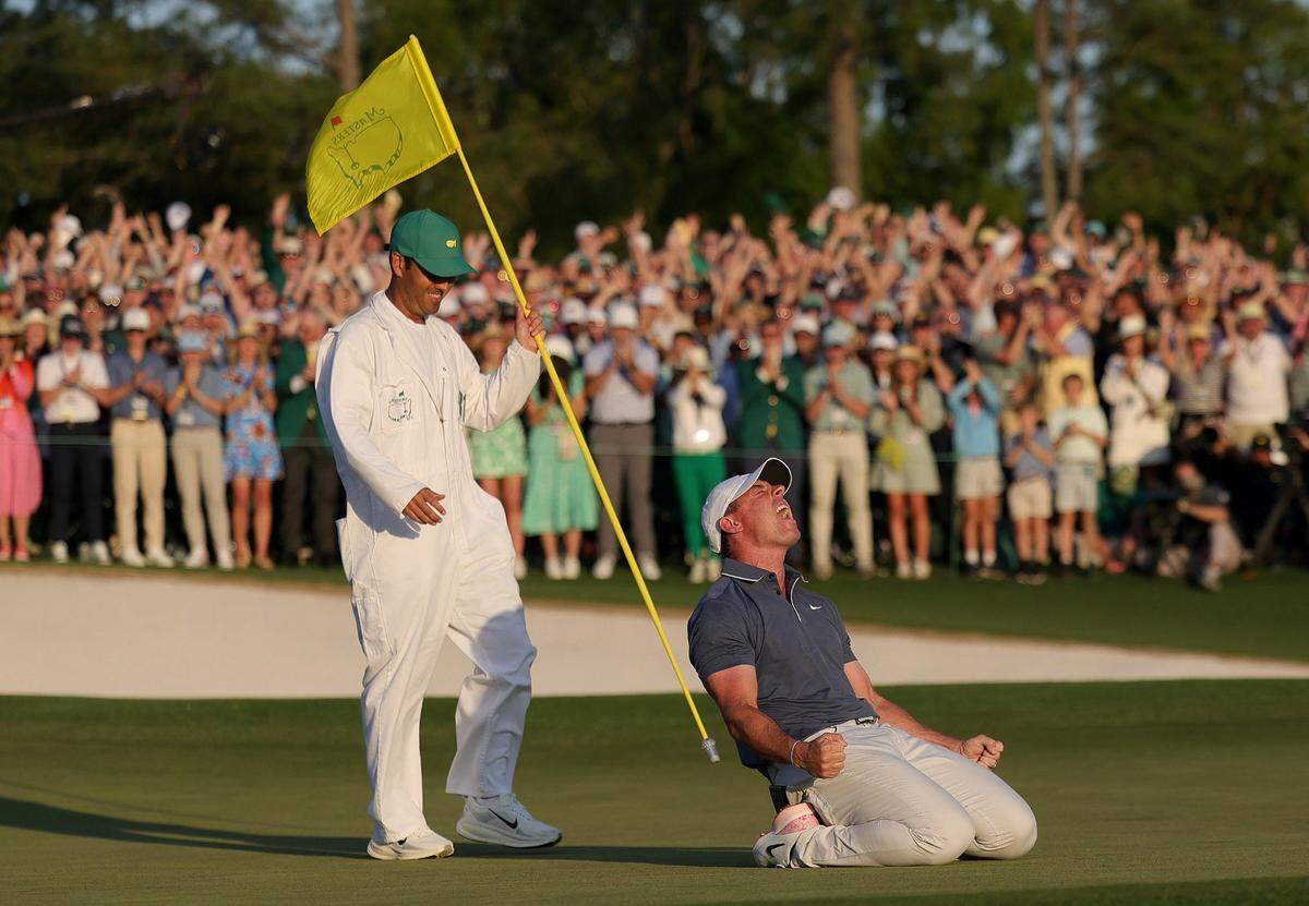 From right, Rory McIlroy of Northern Ireland celebrates winning with caddie Harry Diamond after the playoff hole during the final round of the 2025 Masters Tournament at Augusta National Golf Club on Sunday, April 13, 2025, in Augusta, Georgia.