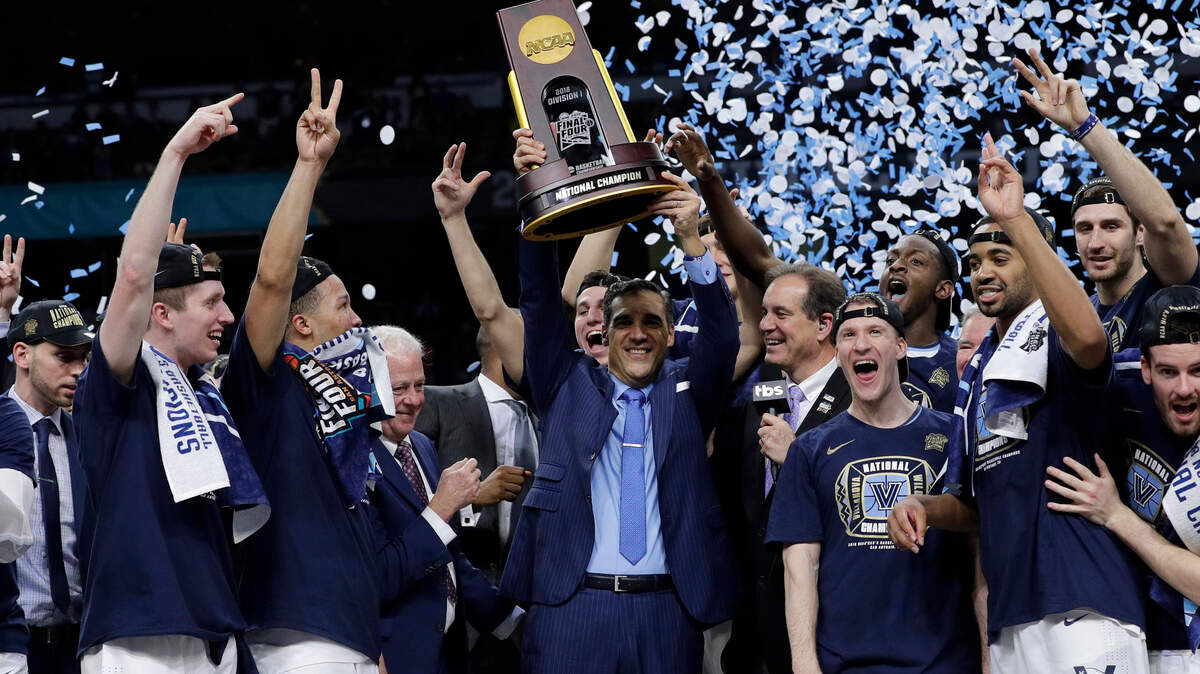 Villanova head coach Jay Wright, center, celebrates with his team after beating Michigan 79-62 in the championship game of the Final Four NCAA college basketball tournament in April. It was Villanova’s second national title in the past three years.