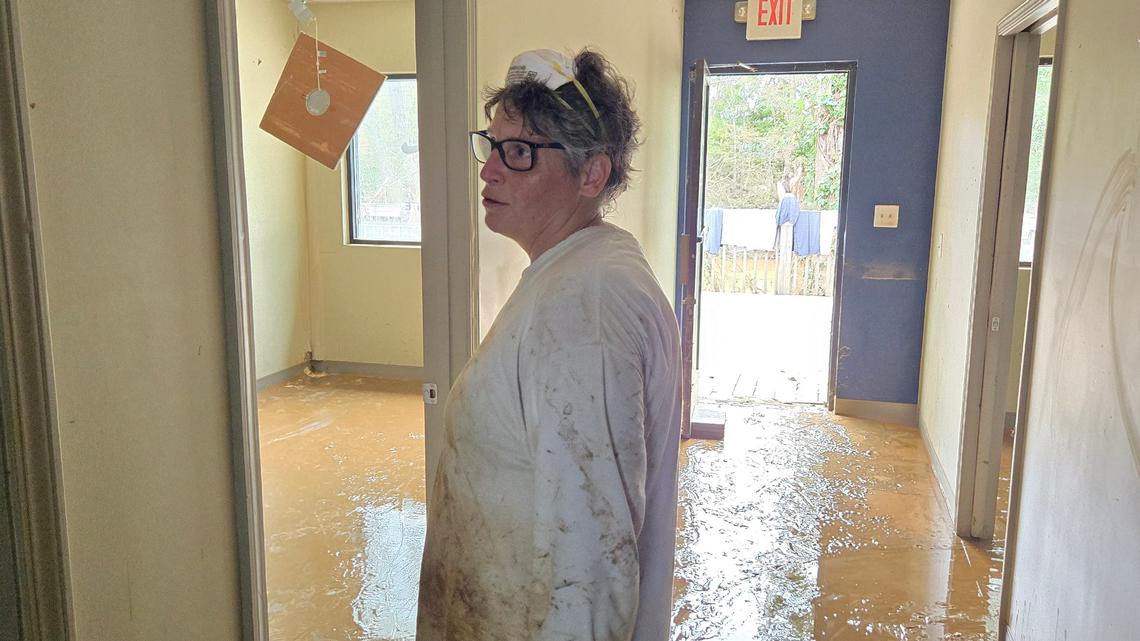 Flossie Amoia takes in the flood damage from Hurricane Helene at Rivers Edge, a physical therapy business in Morganton.